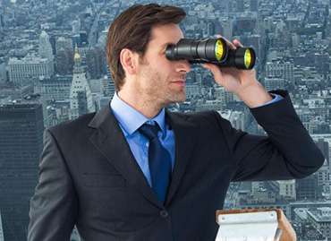 A person looking toward a bright horizon, representing a vision for the future.